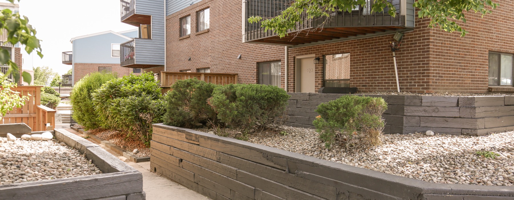 Apartment building exterior with plants and landscaping