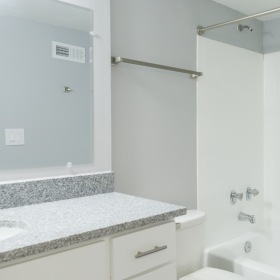 Bathroom with white cabinets and granite countertop