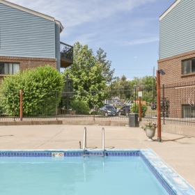 Swimming pool with sundeck facing apartment buildings
